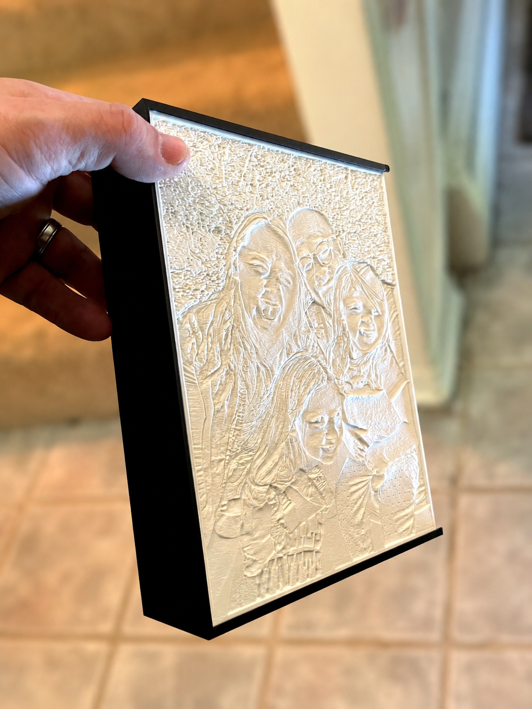 An unlit custom lithophane held in hand.
