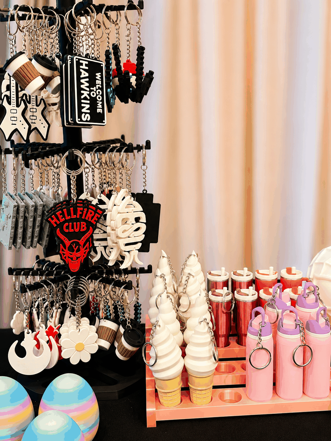 OliPoly market table with keychains, small gifts, and colorful printed pieces