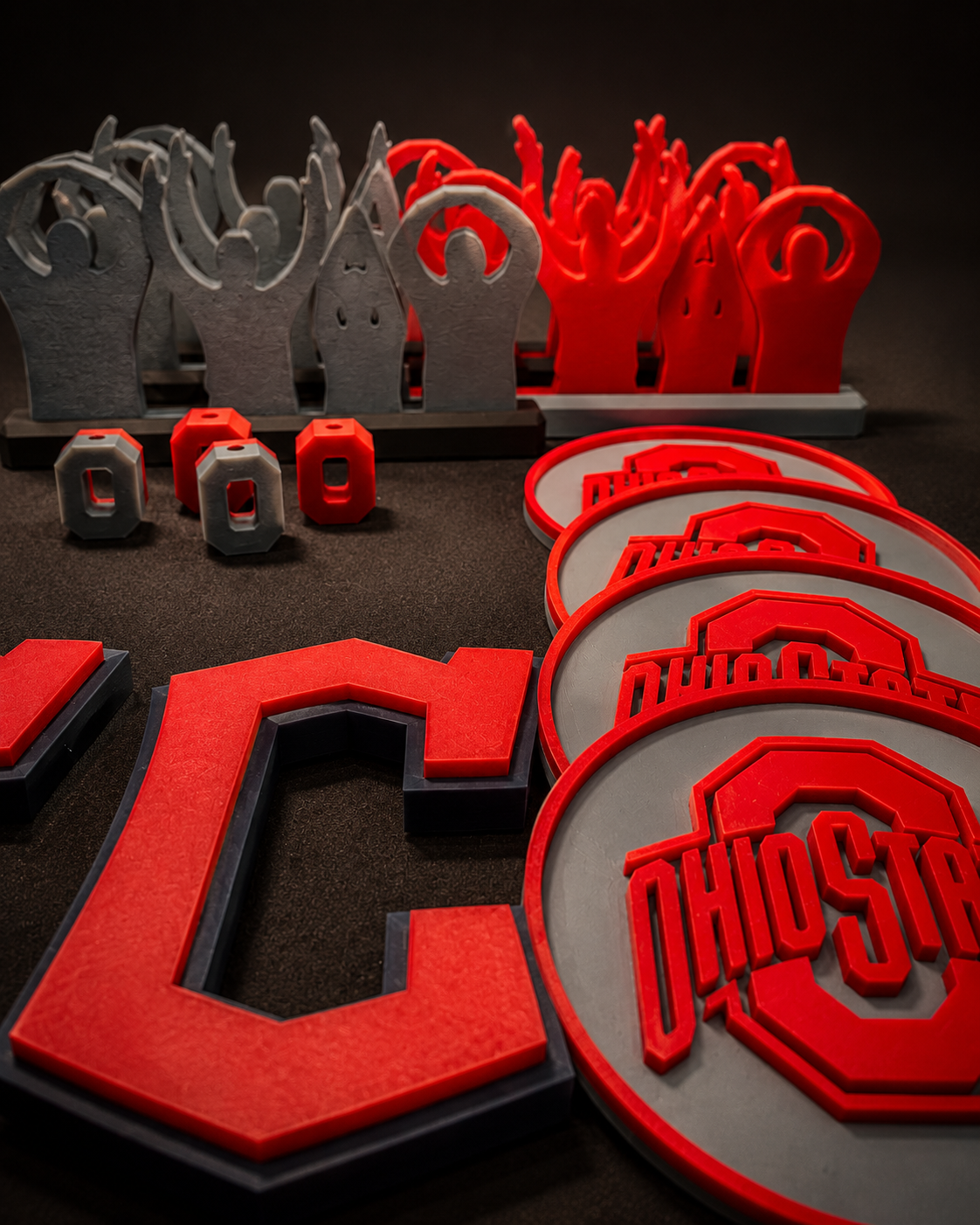 OliPoly tabletop display with bold red and gray printed pieces and coasters