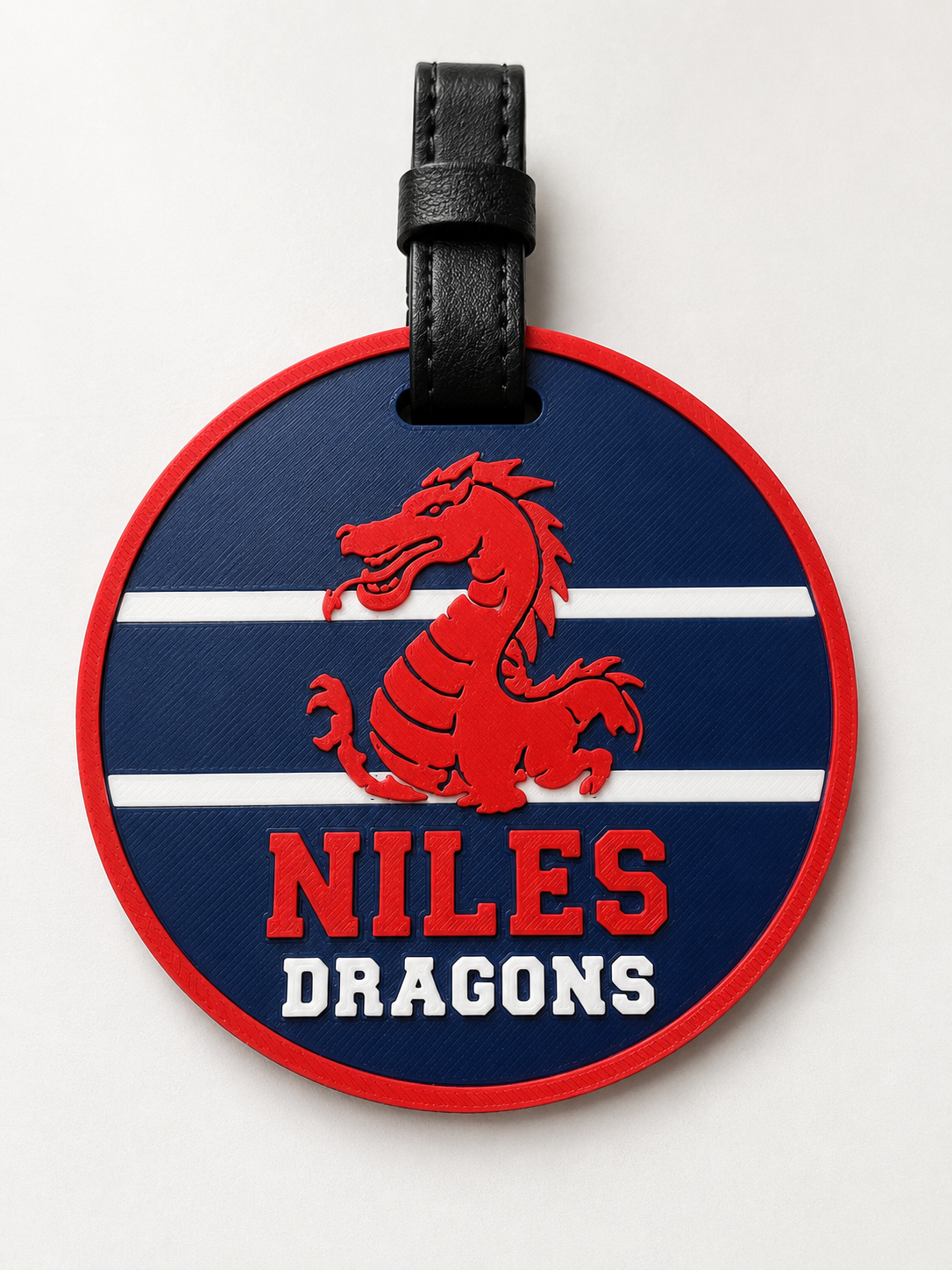 Niles Dragons round bag tag with red dragon and black leather strap