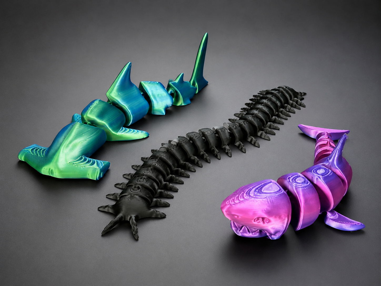 Articulated shark toys arranged in a clean studio scene