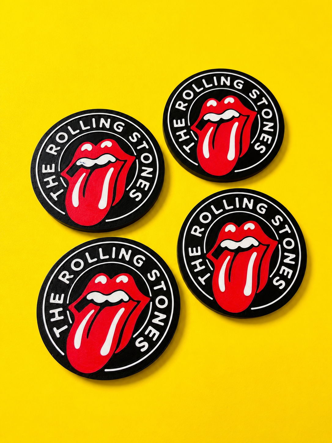 Rolling Stones inspired round pieces on a bright yellow background